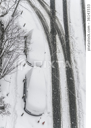 Cars under snow on a parking lot during winter Cars under snow on a parking lot during winter 36143533