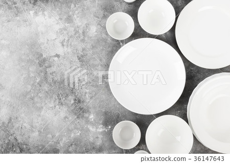 Clean white tableware on a gray background 36147643