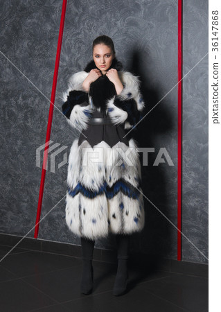 Attractive girl in long bouffant fur coat Attractive girl in long bouffant fur coat 36147868