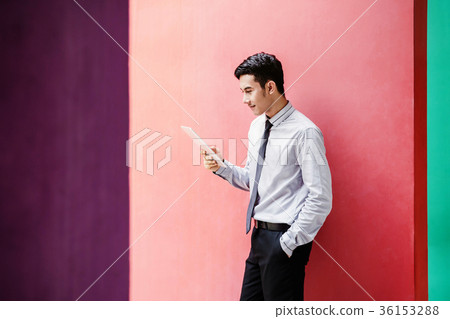 Asian and Happy Businessman Working on tablet Asian and Happy Businessman Working on tablet 36153288