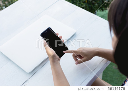 closeup woman hand using phone on table closeup woman hand using phone on table 36156176