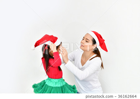 Girls and mom are celebrating Christmas Eve in the house. Girls and mom are celebrating Christmas Eve in the house. 36162664