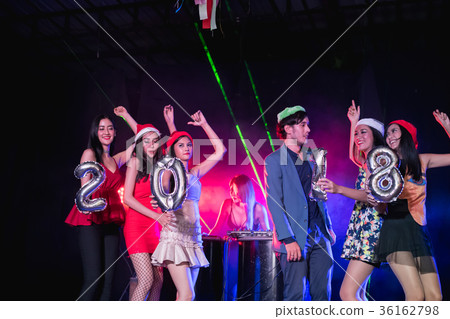 Teenagers are celebrating at the night party. 36162798