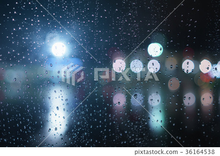 closeup of raindrops on window in night with 36164538