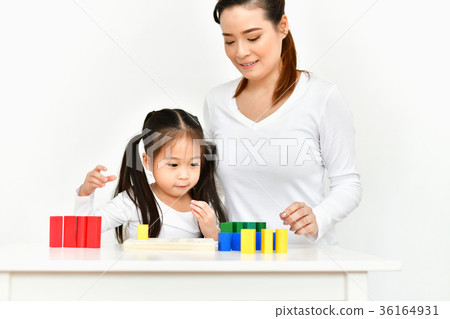 Parents are teaching children to do homework. 36164931