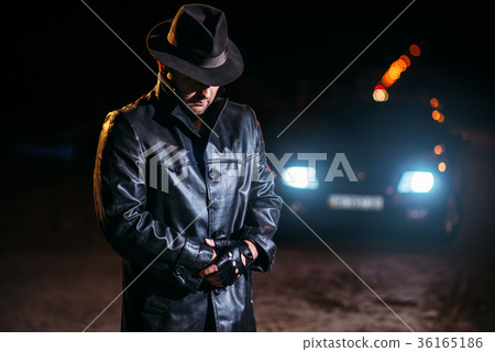 Maniac in black leather coat and hat, back view 36165186
