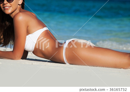 Woman laying by sea Woman laying by sea 36165732