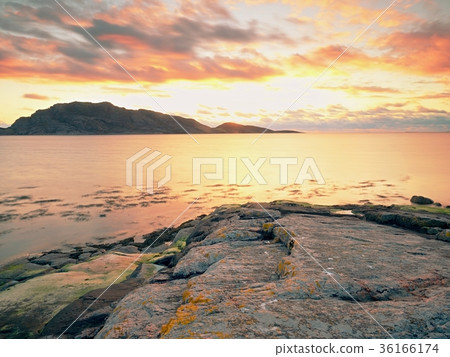 Mirroring of sunsetting horizon in sea water Mirroring of sunsetting horizon in sea water 36166174