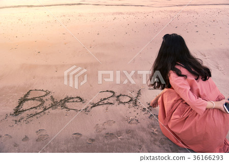 Girl writing Bye 2017 note in the sand Girl writing Bye 2017 note in the sand 36166293