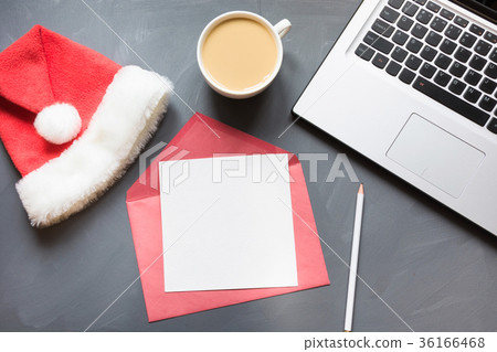 Office workplace with laptop,Santa's caps on gray  36166468