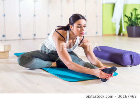 Fit woman doing stretching pilates exercises in 36167462