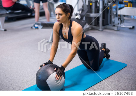 Fit woman exercising with medicine ball workout 36167498
