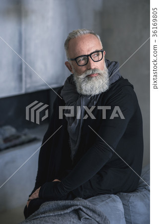 Pensive retire situating in living room 36169805