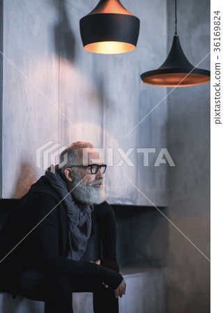 Serene mature male having rest in apartment Serene mature male having rest in apartment 36169824