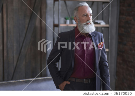 Calm unshaven old businessman situating in Calm unshaven old businessman situating in 36170030