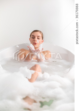 Carefree girl playing with bubbles in bath Carefree girl playing with bubbles in bath 36170868