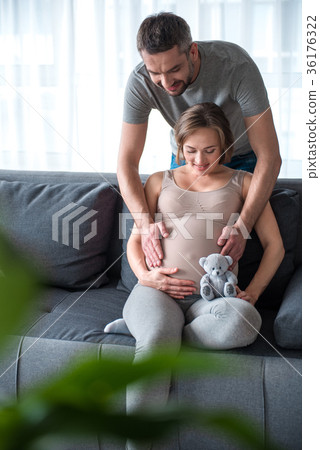 Glad future parents expressing fondness to their 36176322