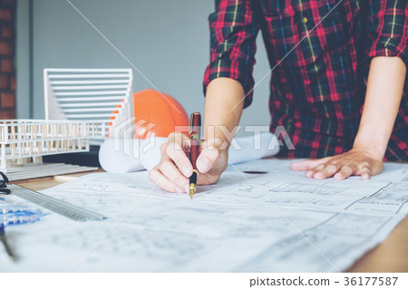 Architect or engineer working in office blueprint Architect or engineer working in office blueprint 36177587