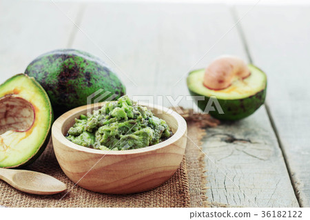 Avocado on wooden floor. 36182122