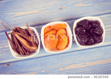Dried fruits in white bowl on wooden boards 36185509