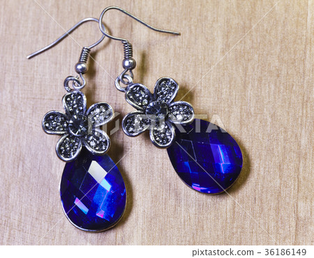 Beautiful earrings with large blue stones on a woo 36186149