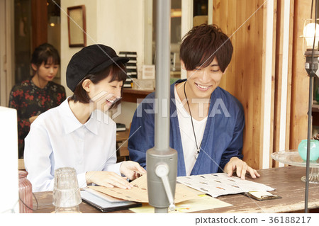 Young people spending time in a cafe 36188217