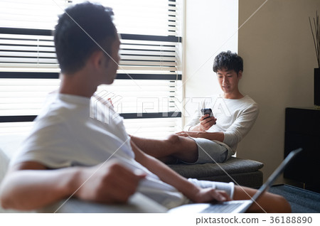 Men relaxing in the living room Men relaxing in the living room 36188890