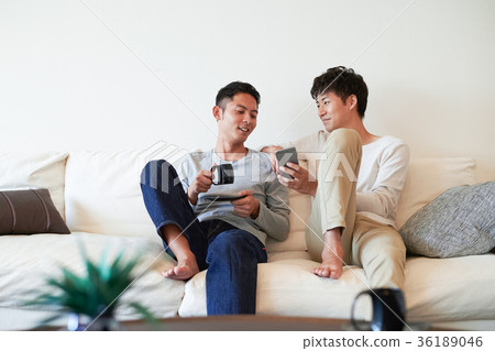 Men relaxing in the living room Men relaxing in the living room 36189046