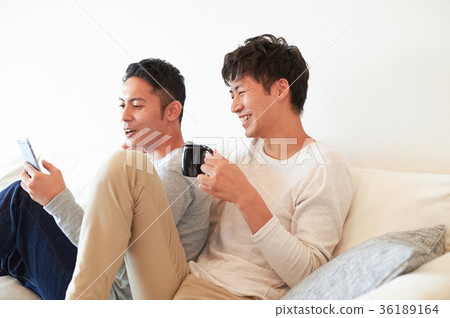 Men relaxing in the living room 36189164