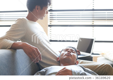 Men relaxing in the living room 36189620