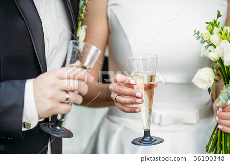 Newlyweds with champagne in their hands 36190348