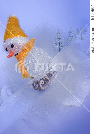 Snowman on sledge in blue background with trees 36190694