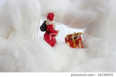 Santa claus in snowstorm with sack and gift 36190695