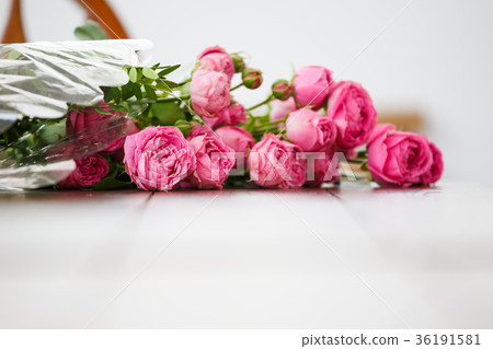 Photo of bouquet of pink peonies on white wooden 36191581