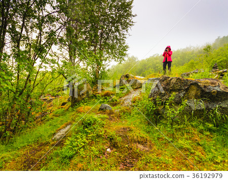 Tourist taking photo in mountains Norway 36192979