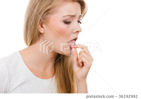 Woman having something disgusting on tongue 36192992