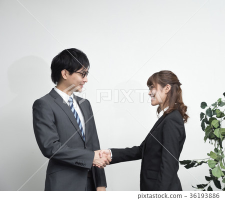 Standing man and woman wearing a suit 36193886