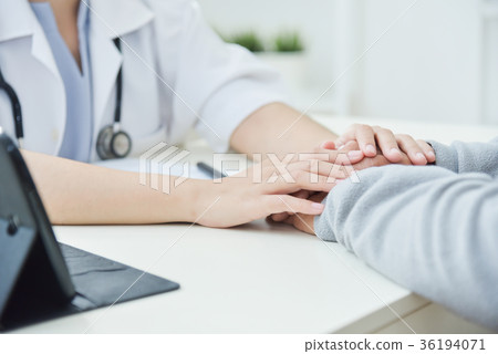 Female doctor reassuring senior male patient. 36194071