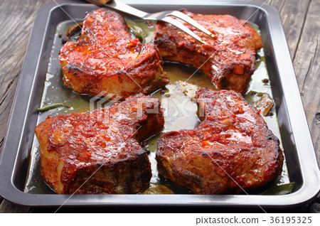 tasty Pork Chops on baking sheet 36195325