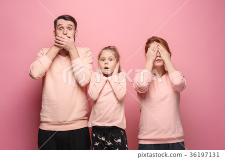 Surprised young family looking at camera on pink Surprised young family looking at camera on pink 36197131