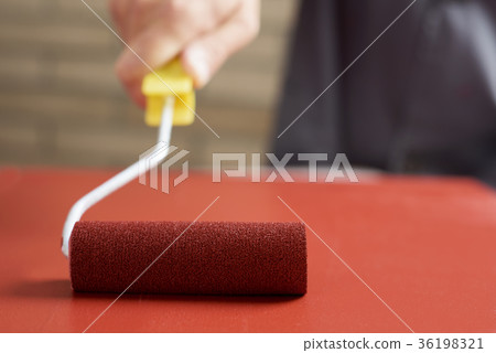 young man painting a wooden board 36198321