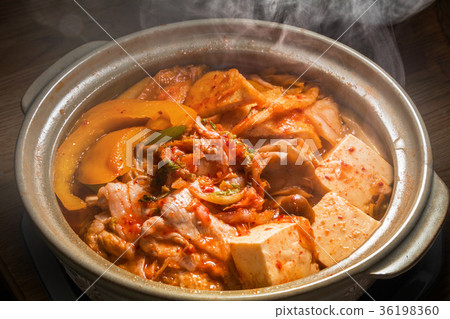 Korean signature Kimchi Stew in a hot ceramic pot served with other side  dishes Stock Photo - Alamy