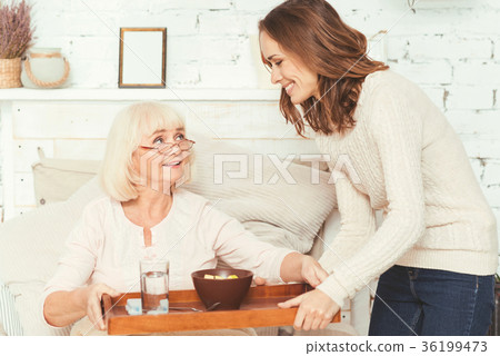 Positive young granddaughter taking care of 36199473