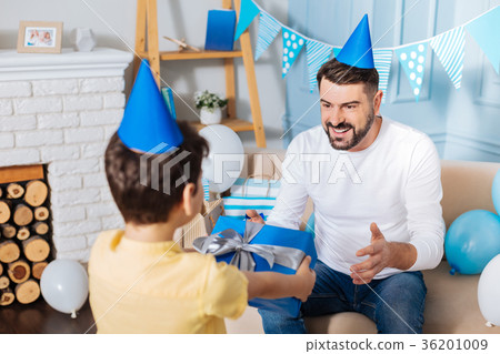 Loving son giving birthday present to his father 36201009