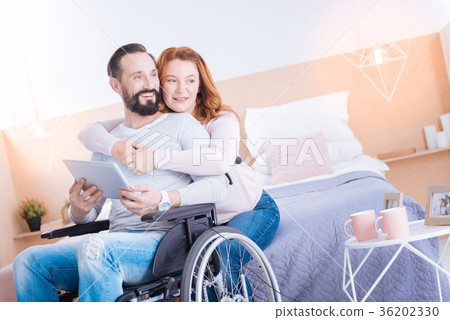 Smiling woman and disabled man relaxing together Smiling woman and disabled man relaxing together 36202330