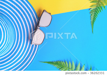 Blue hat and sunglasses on colorful paper Blue hat and sunglasses on colorful paper 36202331