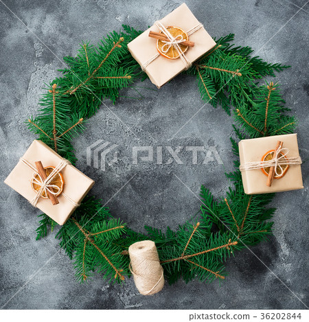 Round frame made of fir branches and gift Round frame made of fir branches and gift 36202844