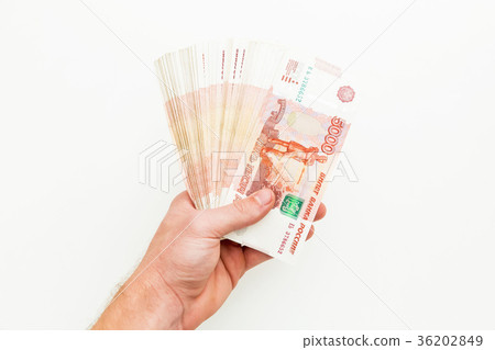 Russian banknote 5000 rubles in men hand on white Russian banknote 5000 rubles in men hand on white 36202849