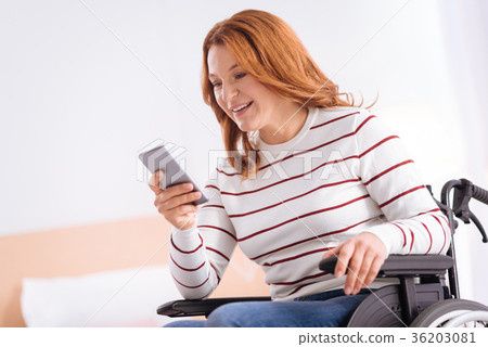Smiling disabled woman in a wheelchair with her Smiling disabled woman in a wheelchair with her 36203081
