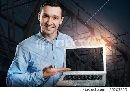Friendly businessman pointing toward screen of 36205235